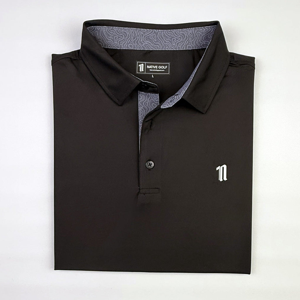 The Caddie Polo, black, folded, topo collar liner