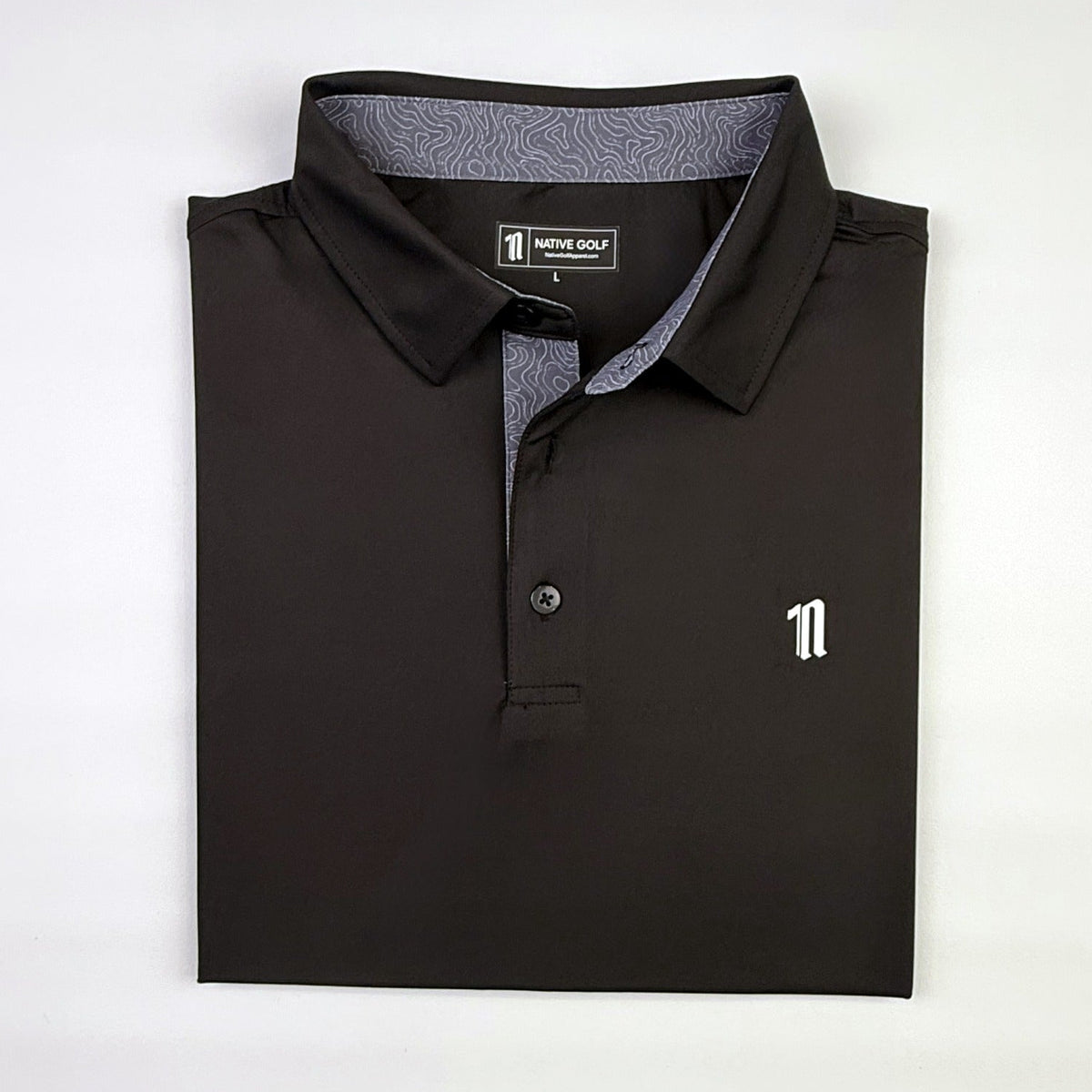 The Caddie Polo, black, folded, topo collar liner