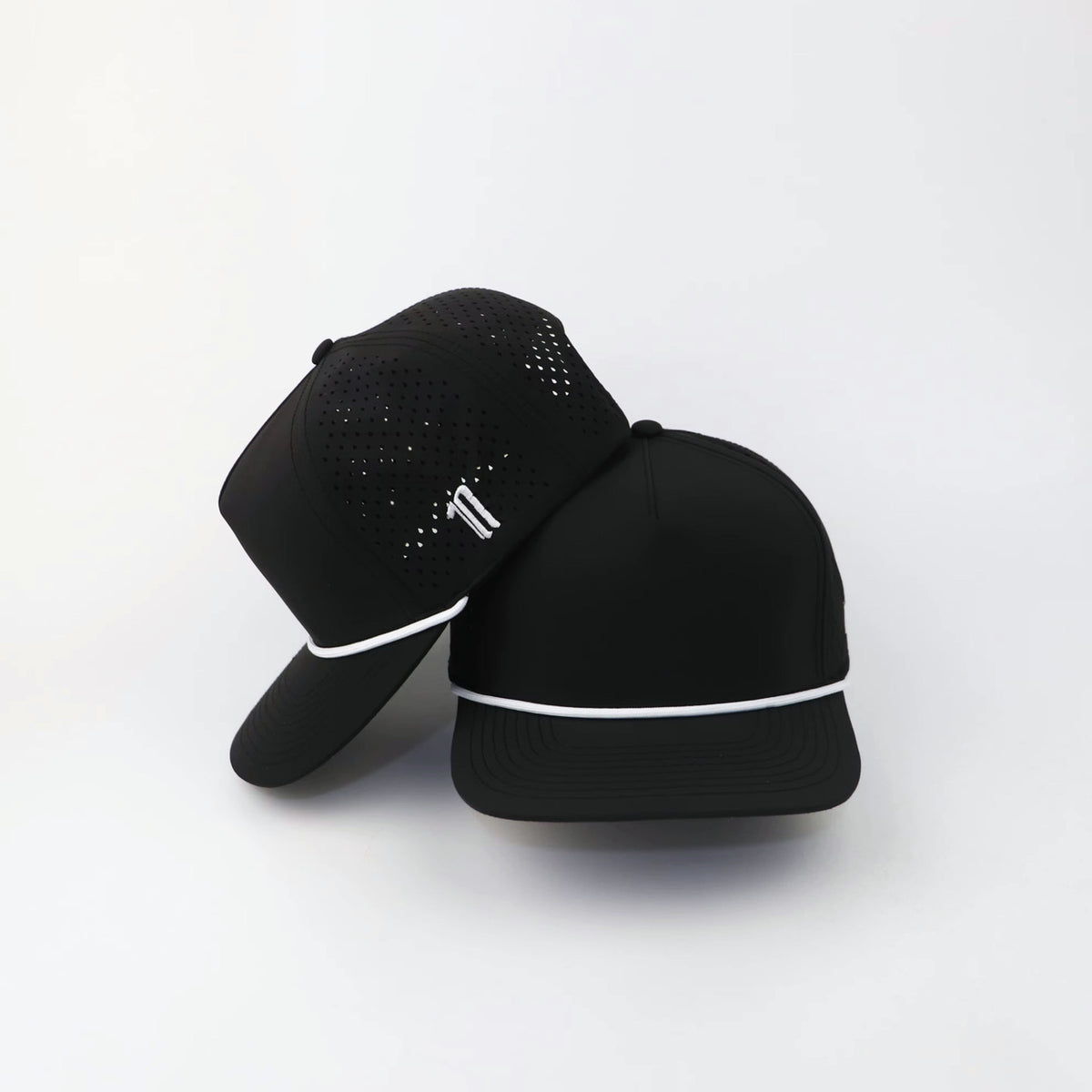 The Eagle "LIGHTS OUT" hat, two hats stacked, side logo