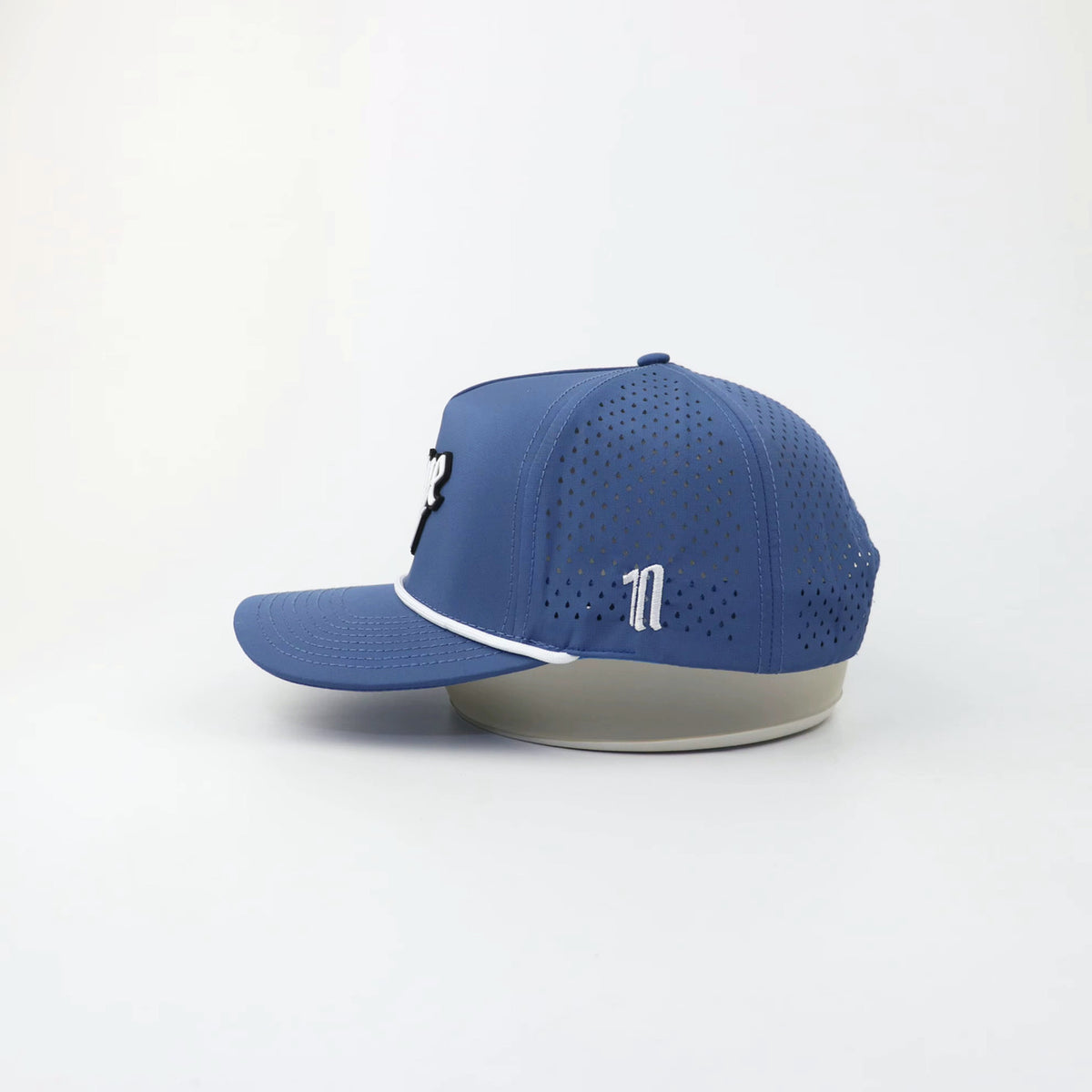 The OG "SHOW OFF" hat, side view showing the laser-cut perforations
